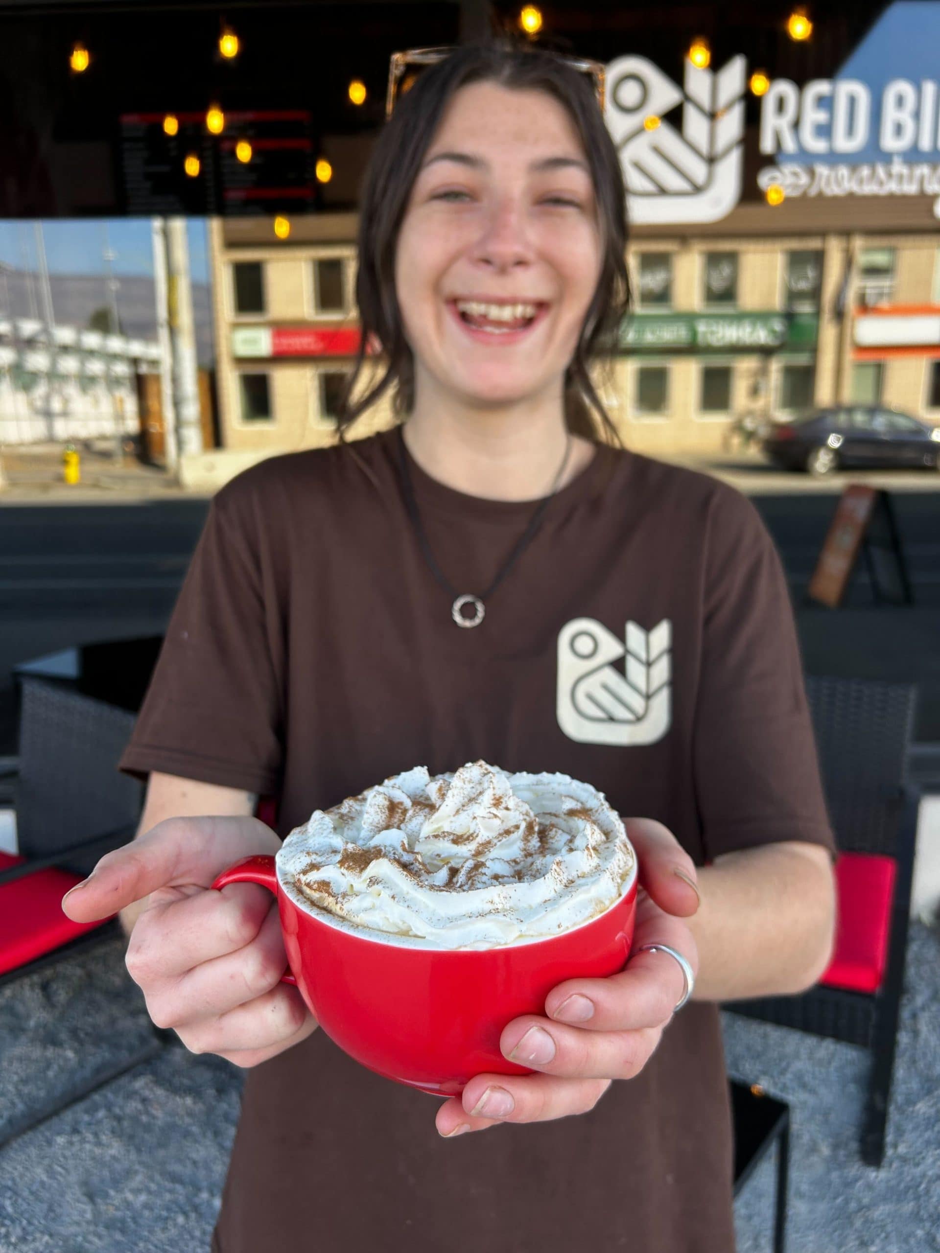 Annie Holding a Pumpkin Spice Latte at Red Bird Roasting