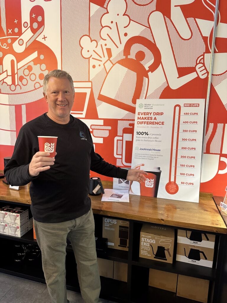 Perry with 100% of Drip Coffee proceeds to JoeAnna's House Sign