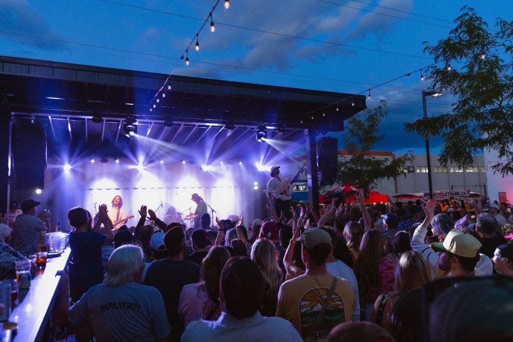 outdoor live music performance and a large crouwed at red bird brewing kelowna